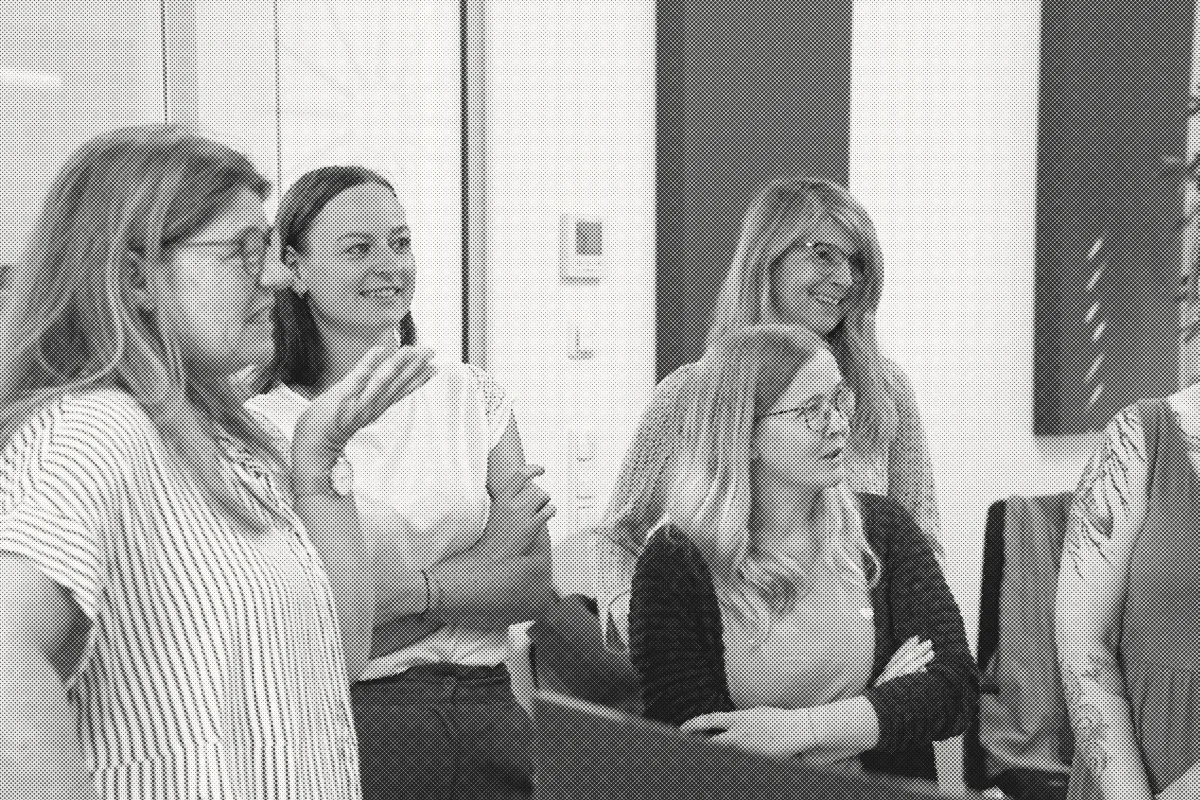 Colleagues in conversation at an event